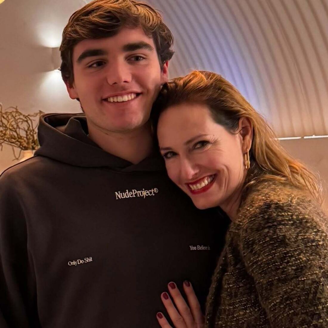 Mulher e homem sorriem; ele veste camisola com 'NudeProject' e frase provocadora