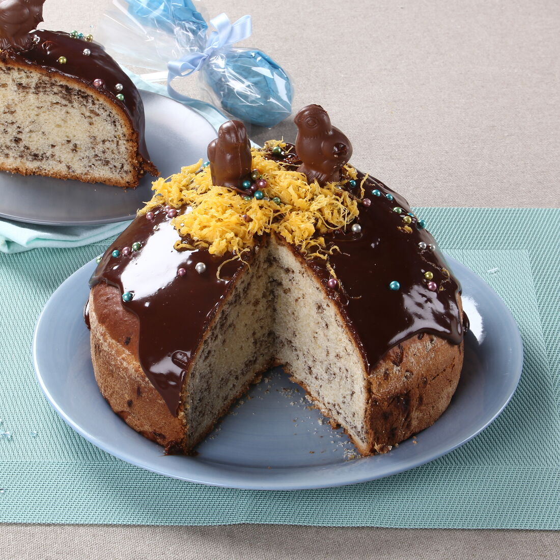 Folar de chocolate, prato pascal decorado com figuras de chocolate e fios de ovos.
