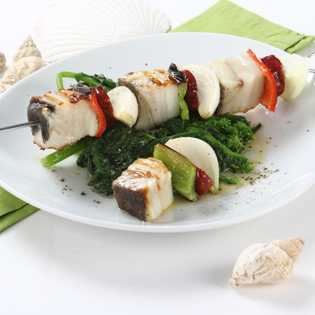 Espetadas de bacalhau com pimentos e cebola, servidas com brócolos