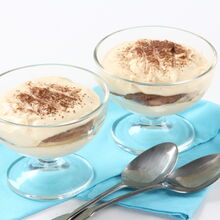 Duas taças de tiramisu com iogurte e cacau em pó