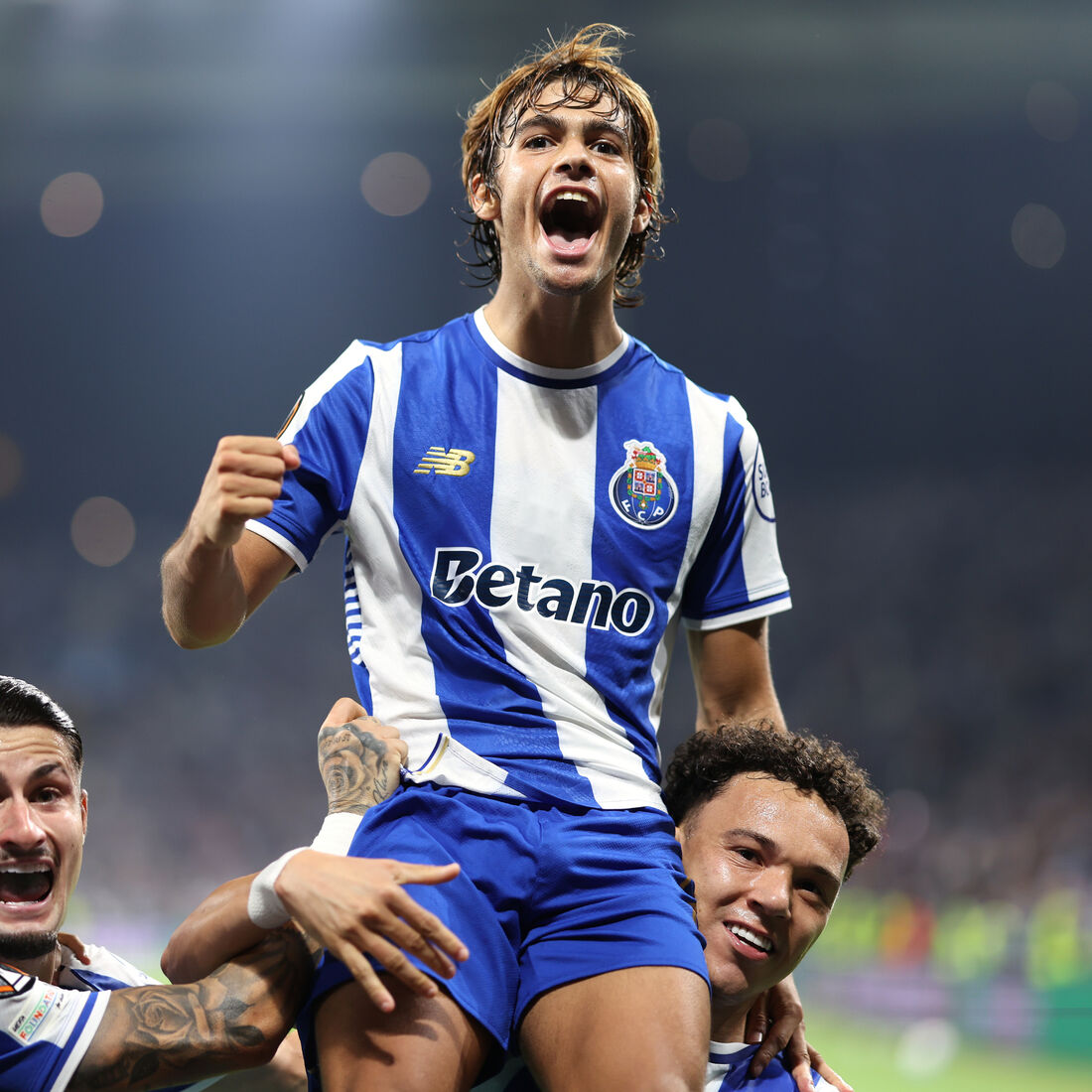 Porto's Rodrigo Mora celebrates on the shoulders of teammate Pepe after scoring his side's second goal during the Europa League